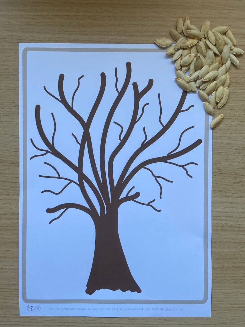Tree with pumpkin seeds leaves craft for preschoolers with free printable tree.
