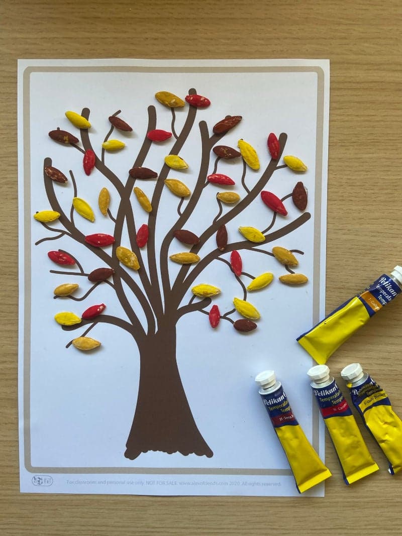 Tree with pumpkin seeds leaves craft for preschoolers with free printable tree.