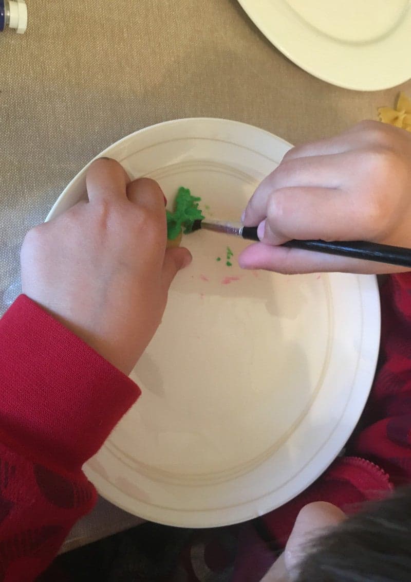 Craft for Easter for kids. Easter egg with colored pasta and beans.