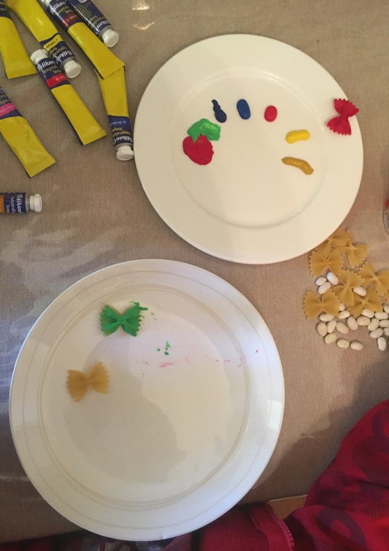Craft for Ester for kids. Easter egg with egg and colored pasta and beans.